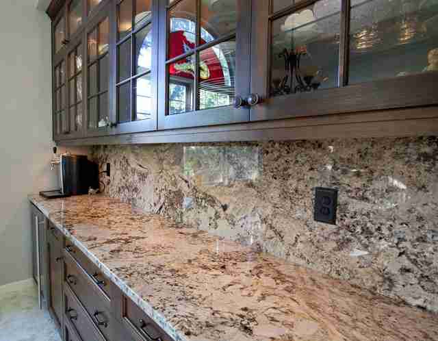 Long, Side-view of a Tan and Brown Granite Countertop and Backsplash in a Residential Home After Professional Granite Polishing Bay Shore Cleaning & Restoration